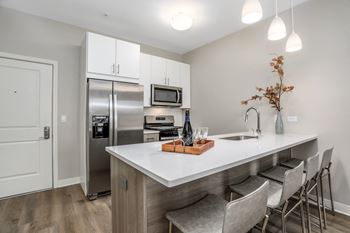 A kitchen with stainless steel appliances and a white counter top